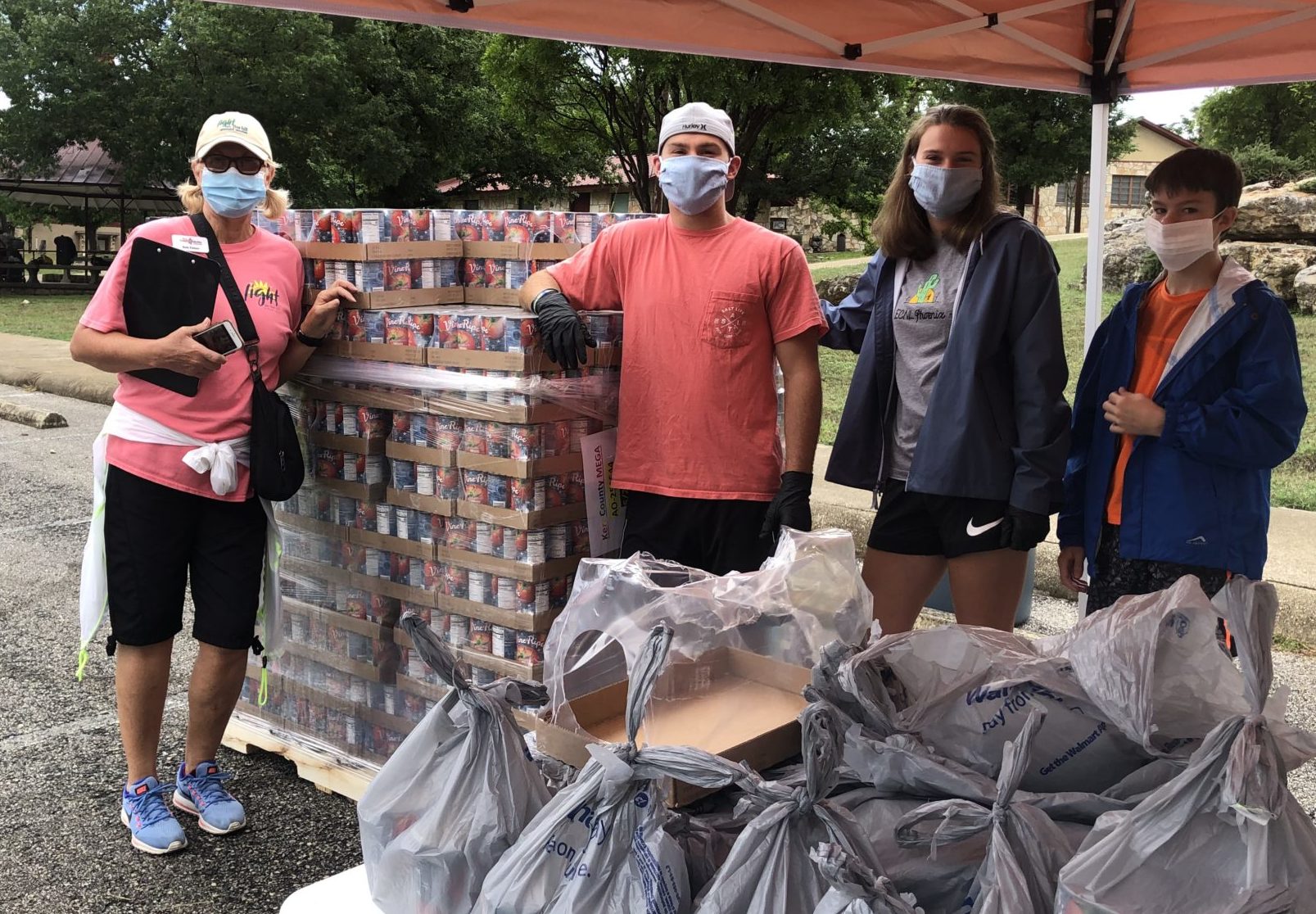 four food drive volunteers wearing masks